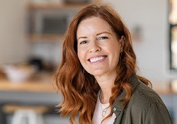 Woman in jacket smiling at home