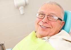 smiling elderly man in the dental treatment chair