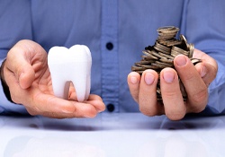 Hands weighing the cost of cosmetic dentistry in New Lenox