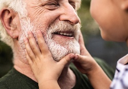 Senior man smiling with dental bridge in New Lenox