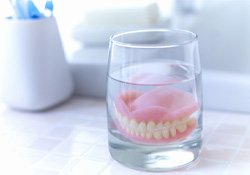 Dentures soaking in glass