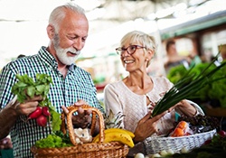 elderly couple buying fresh produce 