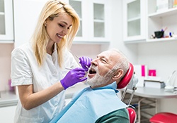 dental hygienist cleaning a patient’s teeth 