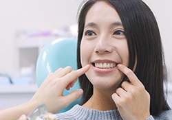 patient pointing to her smile