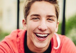 Smiling teenager wearing a red sweatshirt