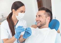Man and his New Lenox dentist discussing Invisalign