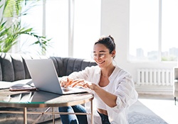 Woman smiling while working at home