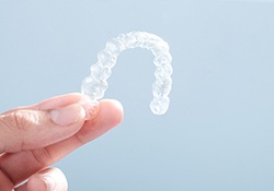 Patient holding clear aligner