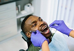 A young man having a dental checkup and cleaning performed