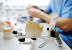 A lab worker creating dentures