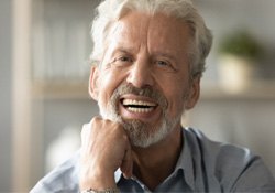 An elderly man adjusting to his new dentures