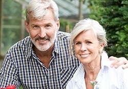 Older man and woman smiling outside