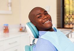 Male dental patient smiling after root canal therapy in New Lenox, IL