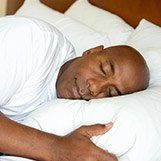 Man sleeping soundly in bed