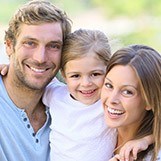 Smiling mother father and child outdoors