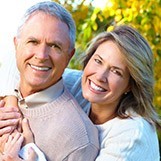 Smiling older man and woman outdoors