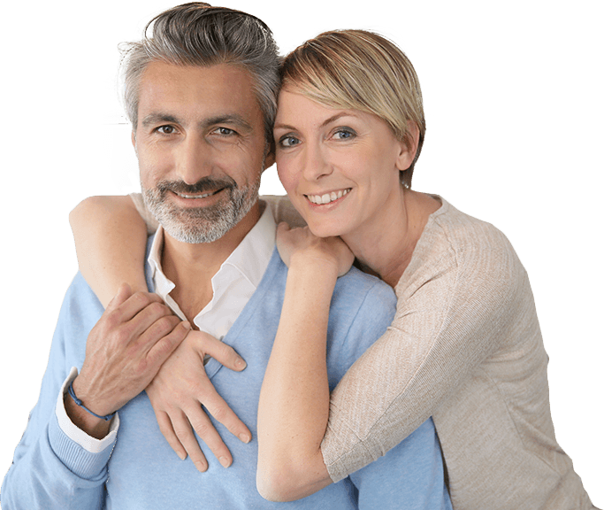 Smiling older man and woman holding each other