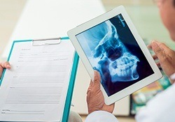 Patient chart and full face x-rays examined