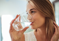 woman drinking a glass of water