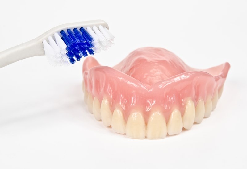 example of toothbrush cleaning dentures in New Lenox