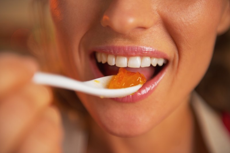 person eating representing dentures and taste in New Lenox