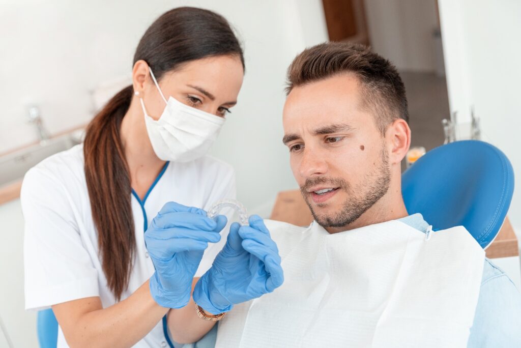 Dentist shows patient clear aligner