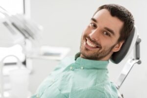 Adult man smiling after his fluoride treatment