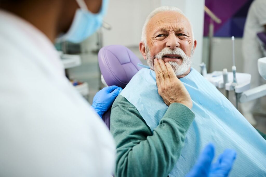 A man with denture sores in a dental chair