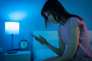 a person using their cell phone in bed